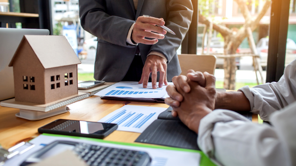 A person pointing at a chart during a business discussion.